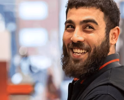 A man with a beard smiling.