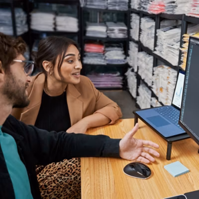 A one man and one women working on computer
