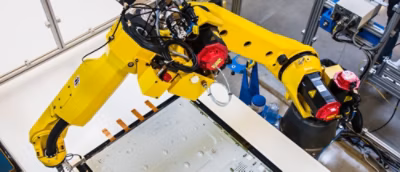 A yellow robotic arm with a red and black motor.