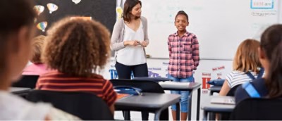 A teacher standing in front of a group of students.