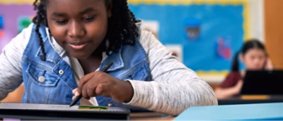 A child drawing on a tablet.