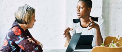 A man and a woman looking at a computer screen.