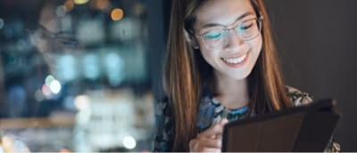 Closeup of a woman wearing specs looking at the tablet