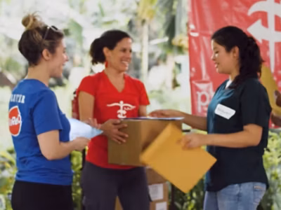 A group of Project CURE team members distributing medical supplies. 