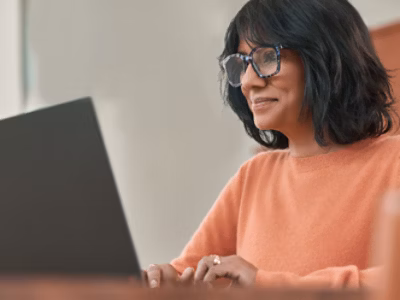 A woman with spectacles working with laptop