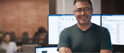 A man wearing glasses smiling.