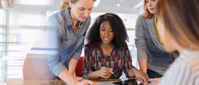 A group of women looking at a tablet.