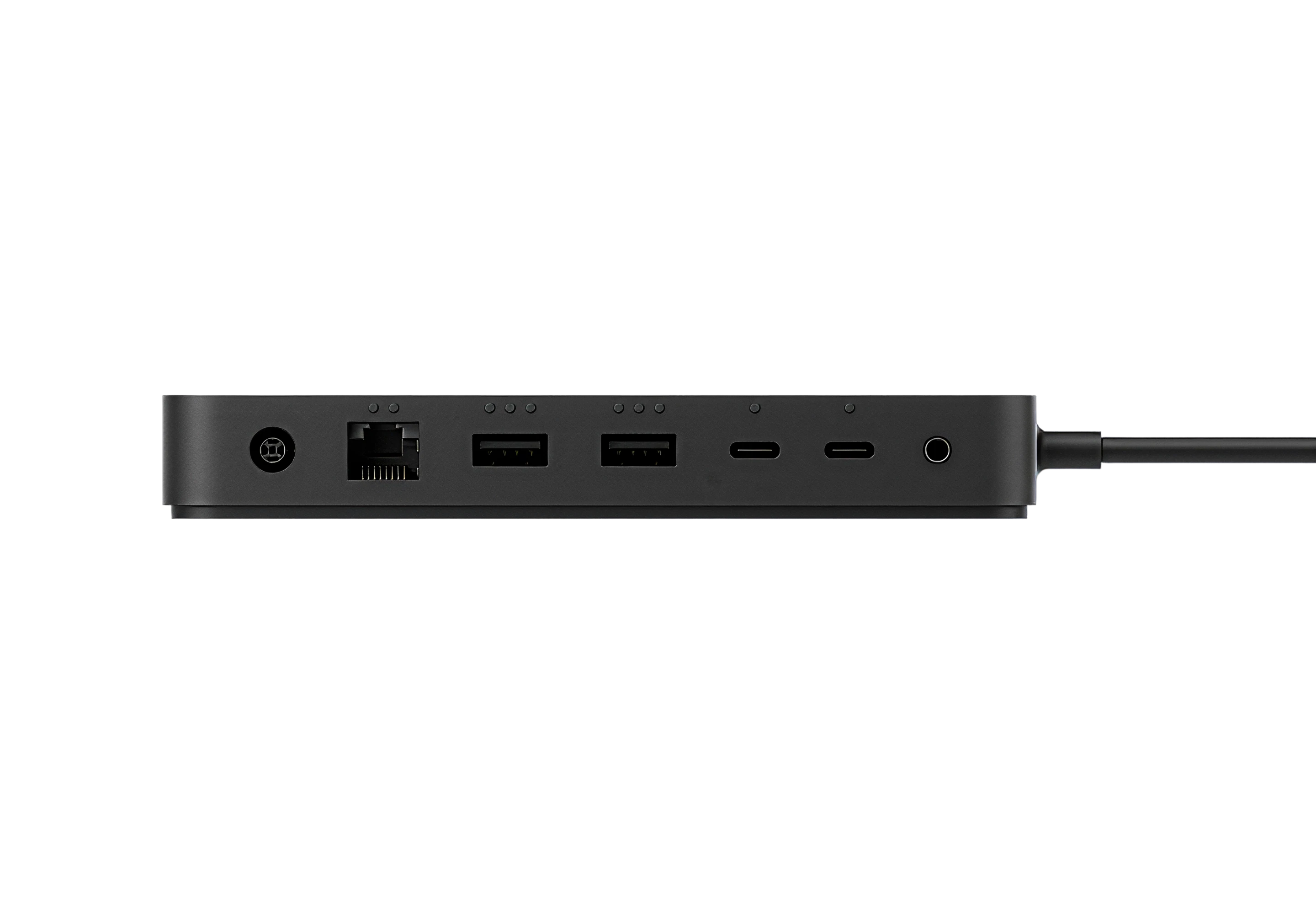 Close-up side view of a Surface Dock showing multiple ports including Ethernet, USB-A, USB-C, and audio, with a connected cable on a dark background