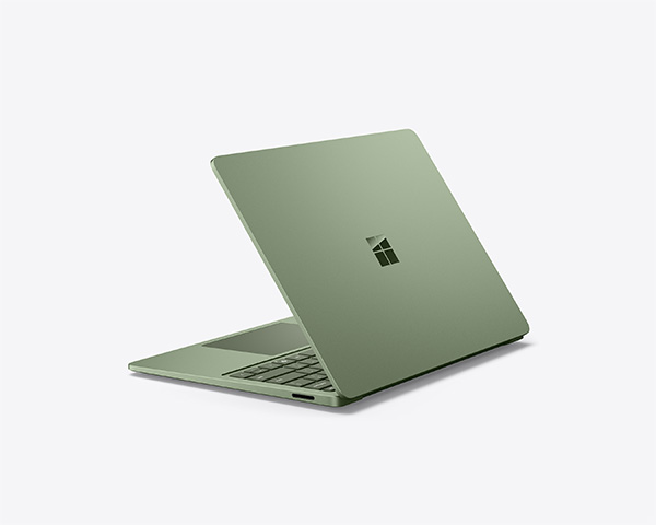 Jade Surface laptop partially open on a light background