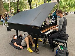Colin Huggins performs piano for an audience in 2021